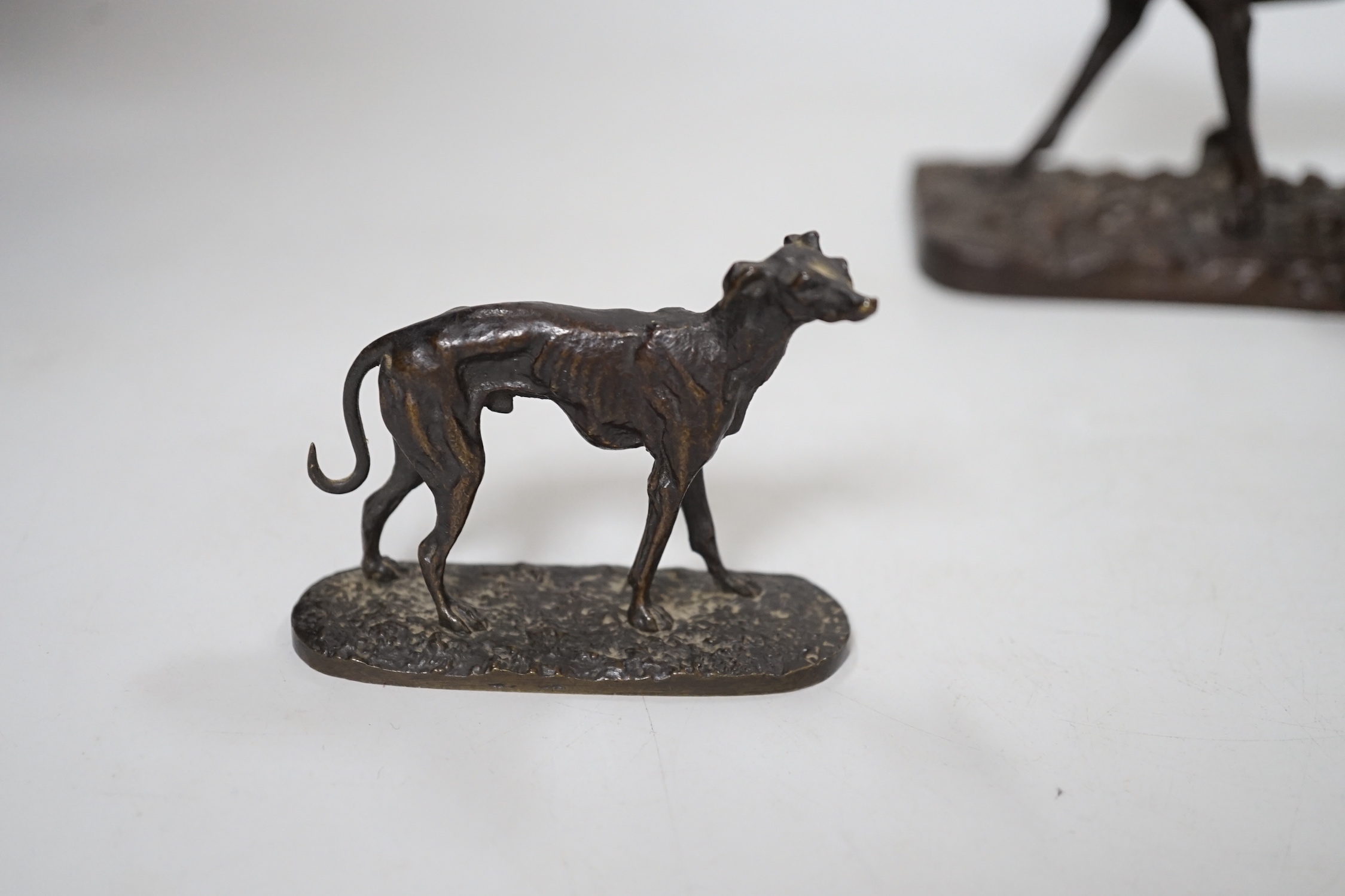 After Pierre-Jules Mêne (1810 – 1879) a patinated cast iron hound and a similar small bronze figure of a greyhound, the largest 18cm wide